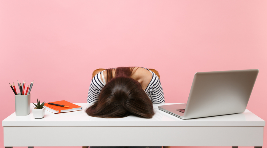 Stressed marketer with head on desk