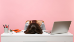 Stressed marketer with head on desk