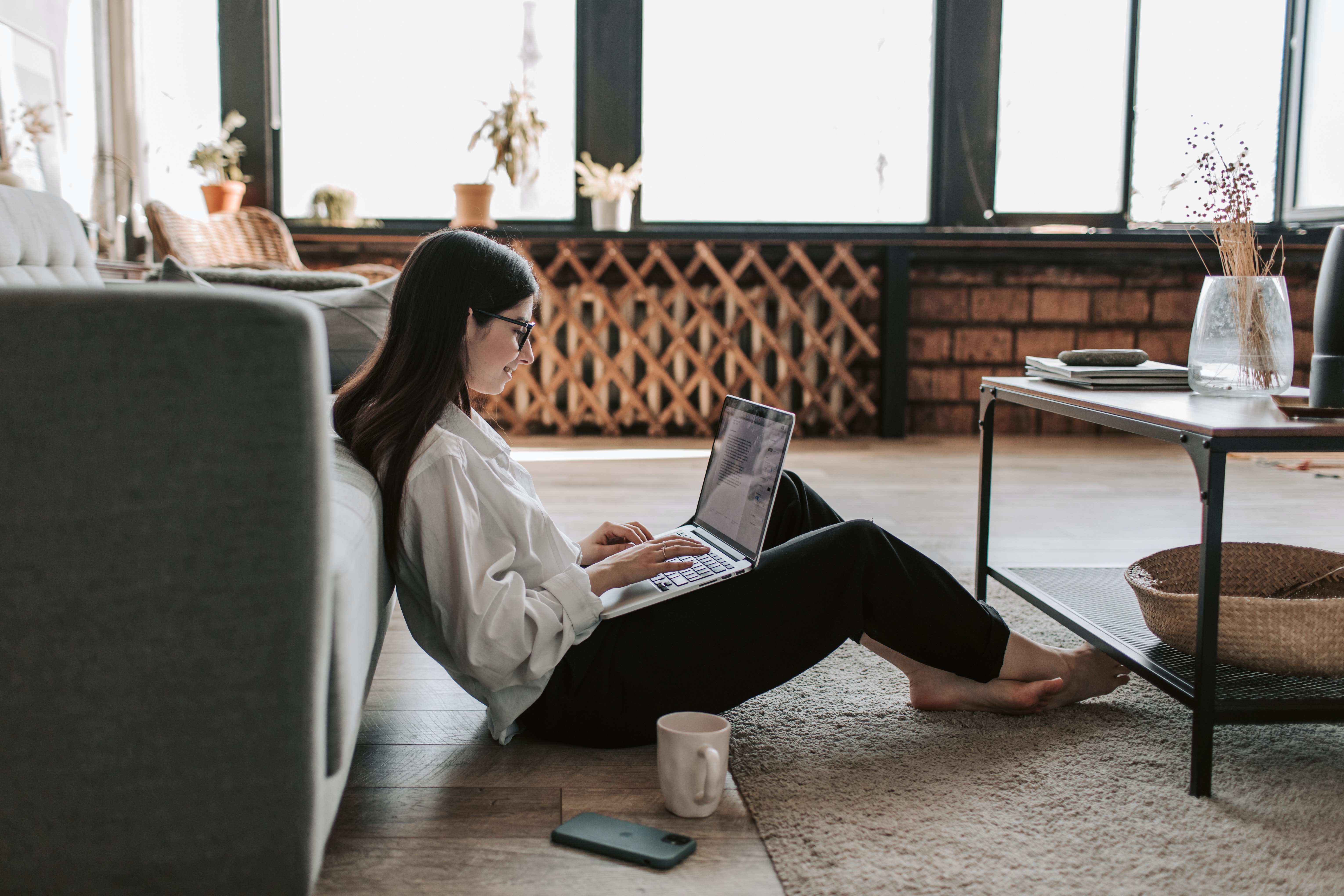 woman working on laptop on the floor at home