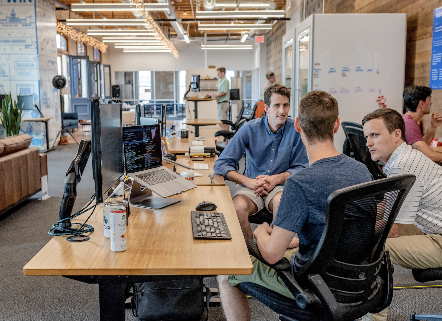 Men sat around a desk discussing