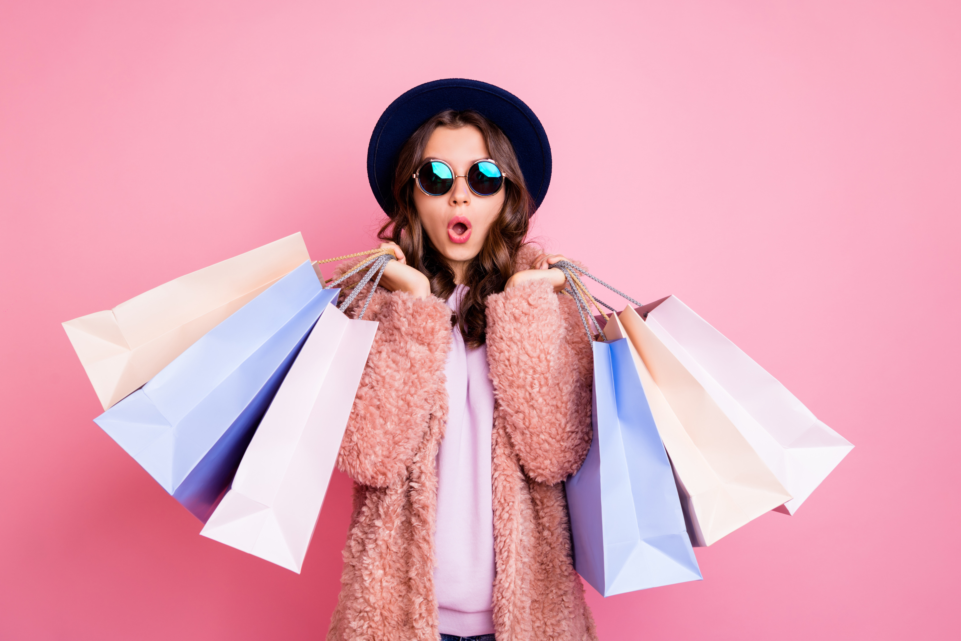 A woman holding several shopping bags.