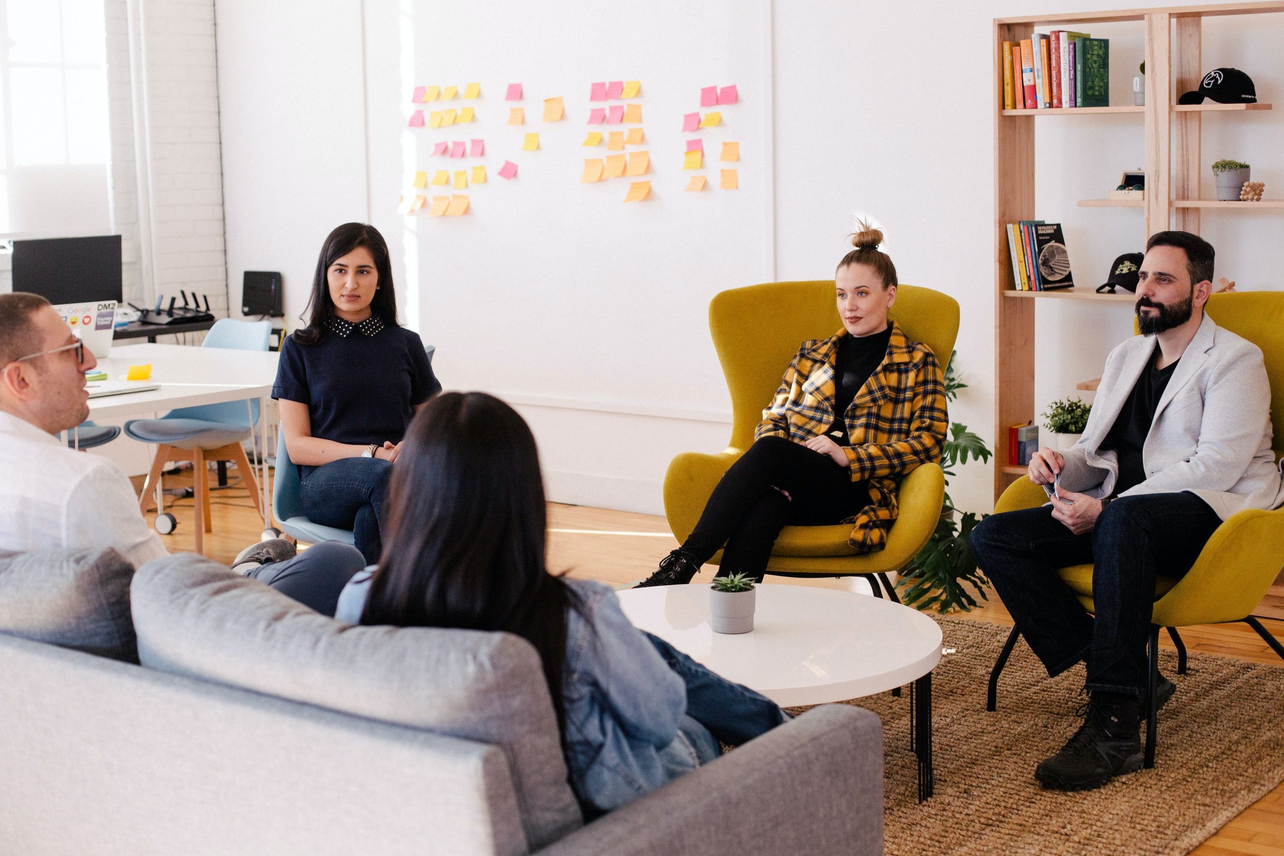 People sat around a coffee table in an office