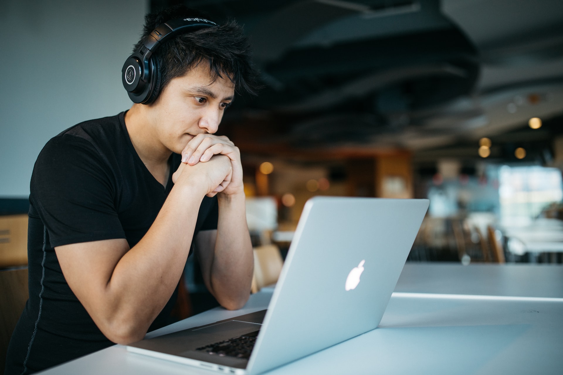 Man looking at Apple laptop