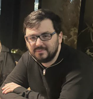 A photo of Matthew sitting at a table