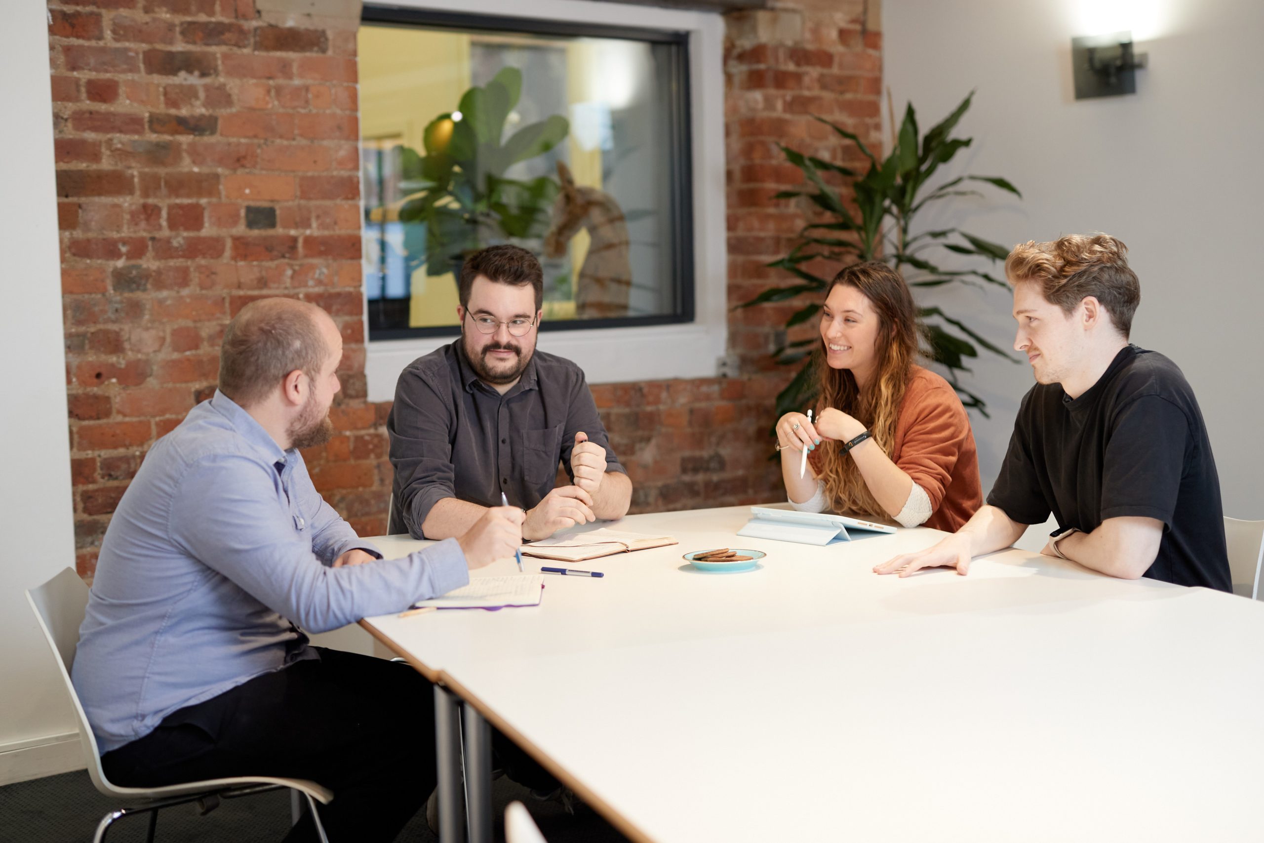 Huddle team sat around a meeting table