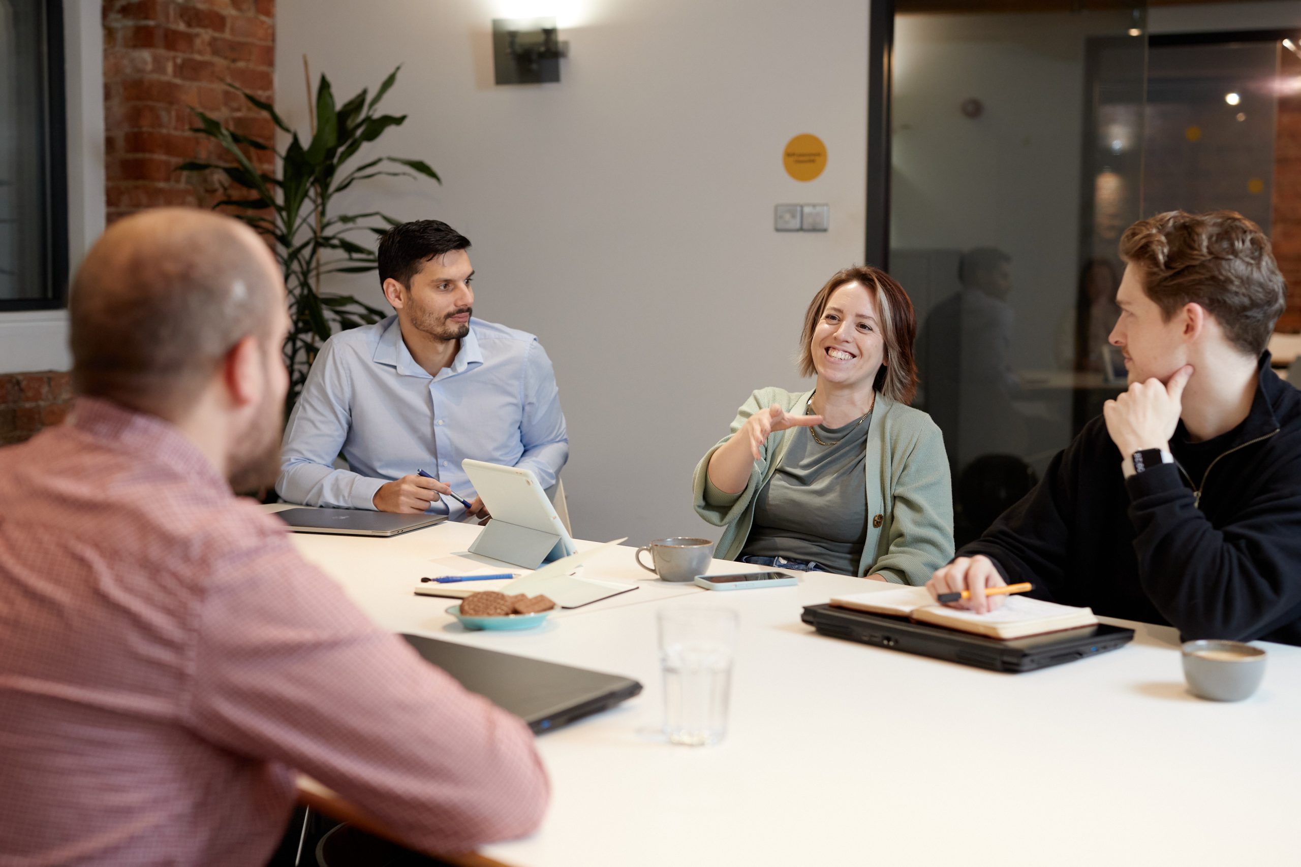 Woman talking at meeting table