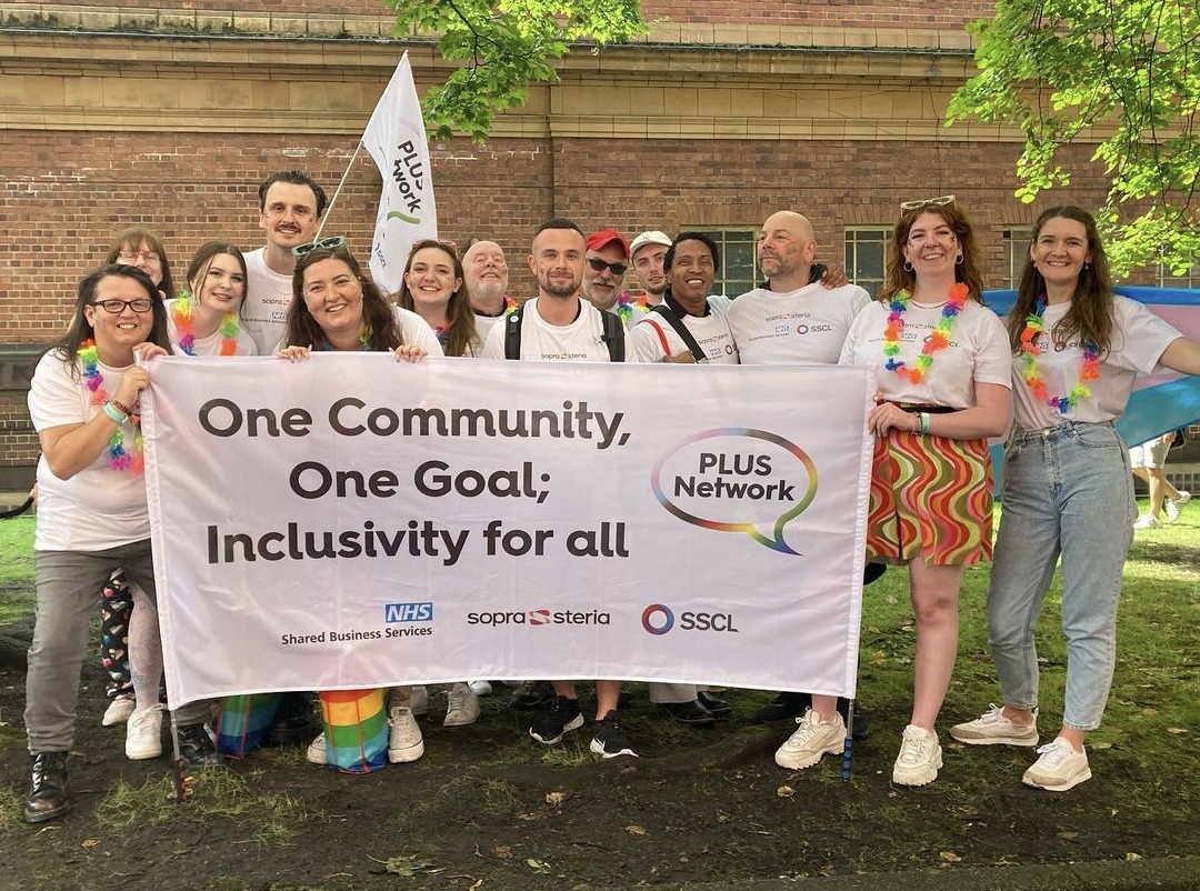 Members of our PLUS network holding a flag