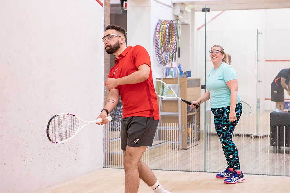 Two people playing squash