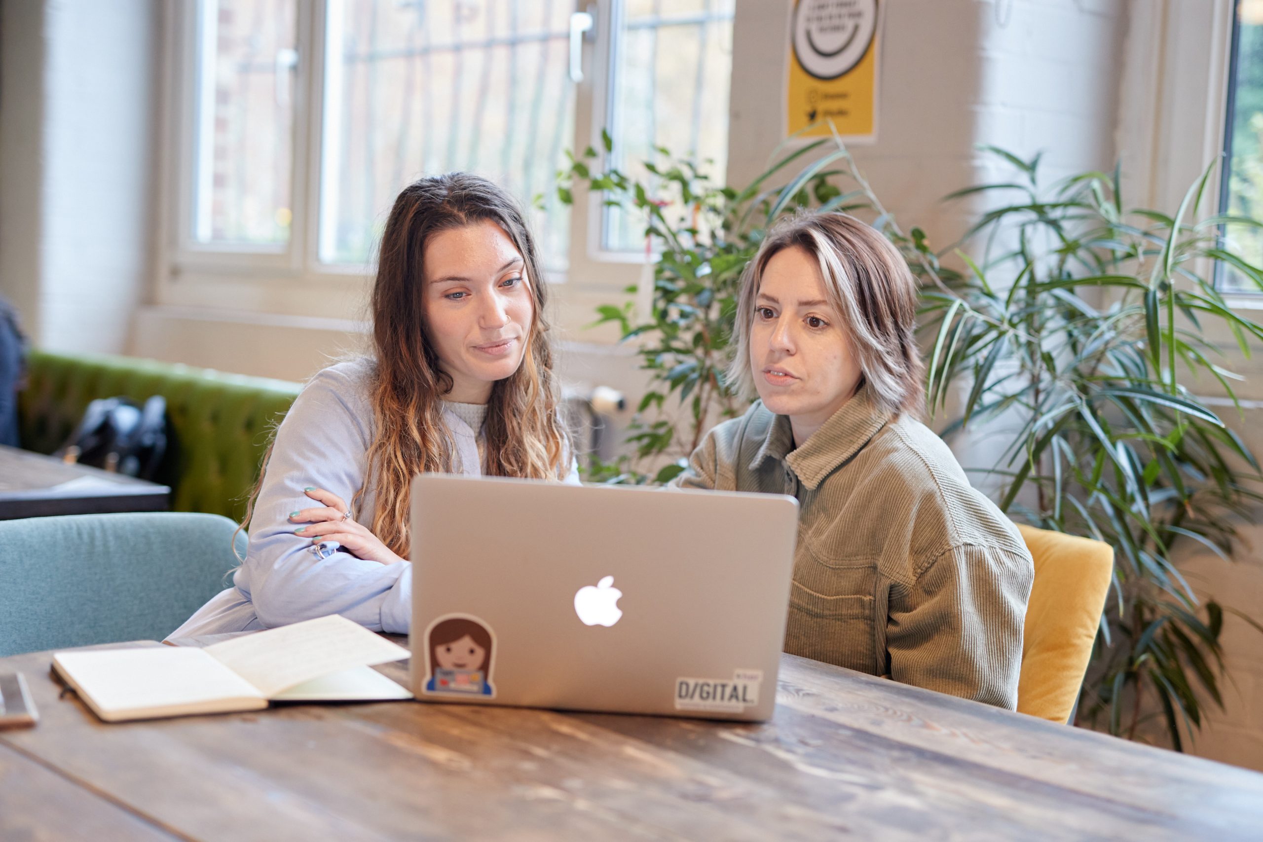 Two women looking at a laptop