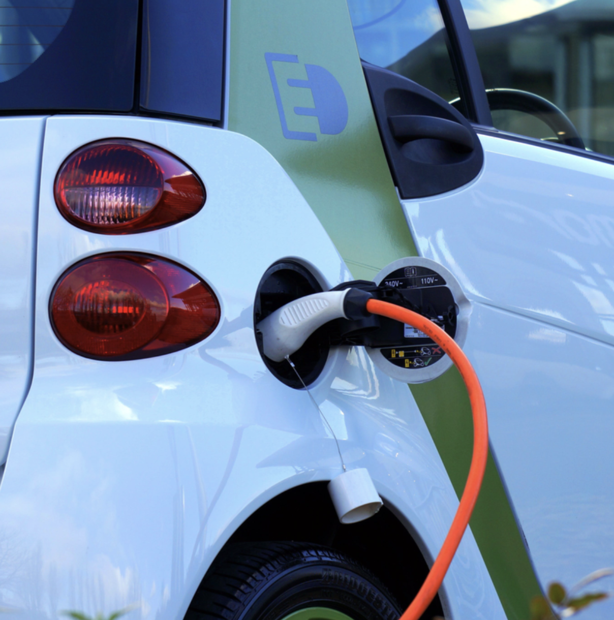 An electric smart car being charged.