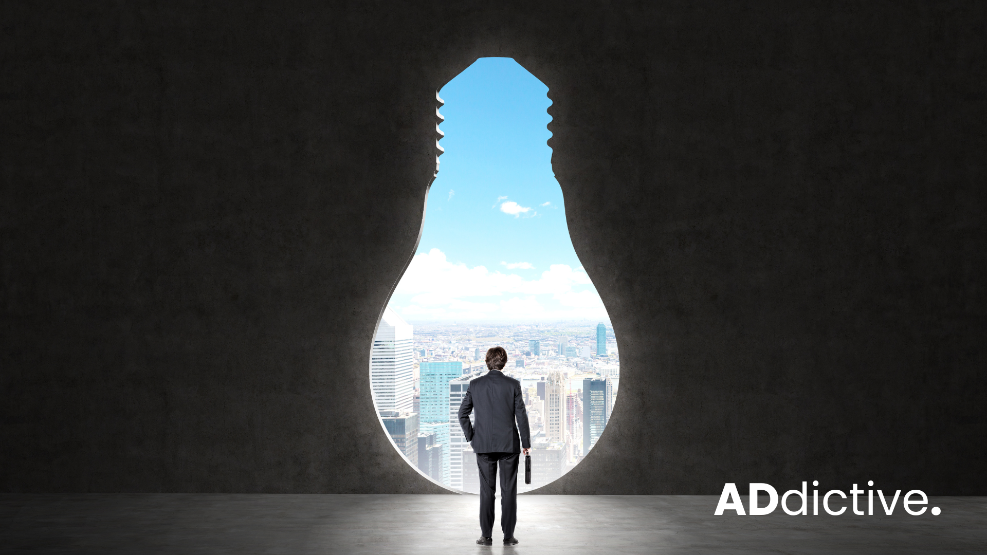 Business man standing infront of a lightbolb shaped enterance to a city.