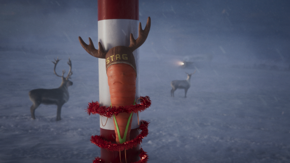 Kevin the Carrot strapped to the North Pole in a mankini