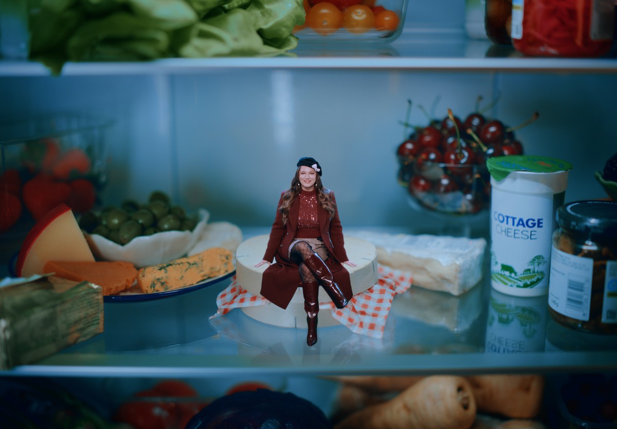 Kelly Brook sitting on some cheese.