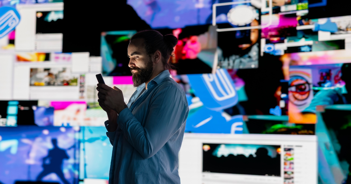Person viewing multiple digital video screens representing modern video consumption and marketing opportunities.