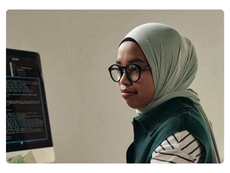 Female digital apprentice works at computer