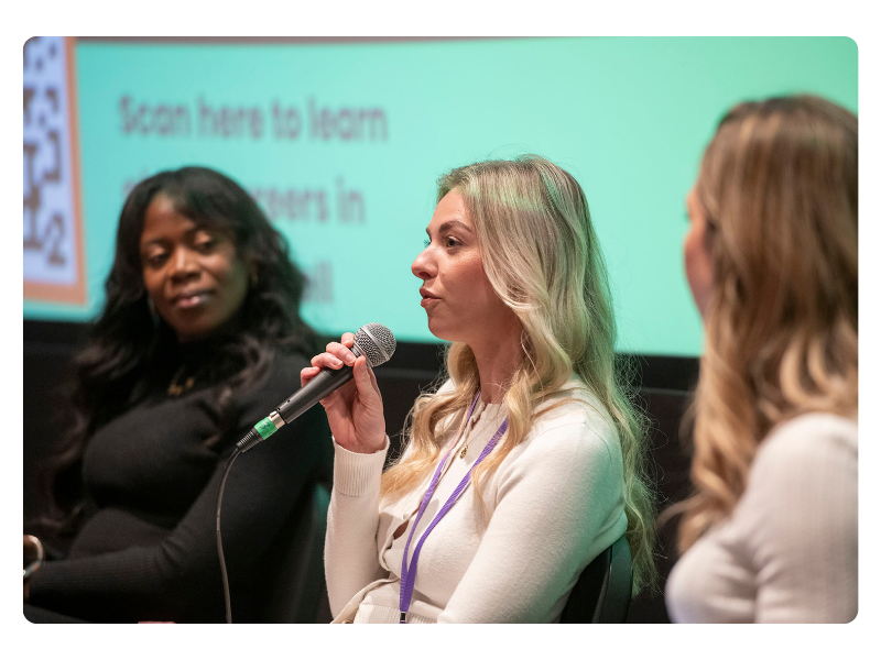 Female speakers on stage at a Digital Her event