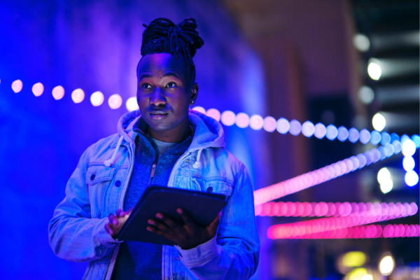 A man at night with a table device