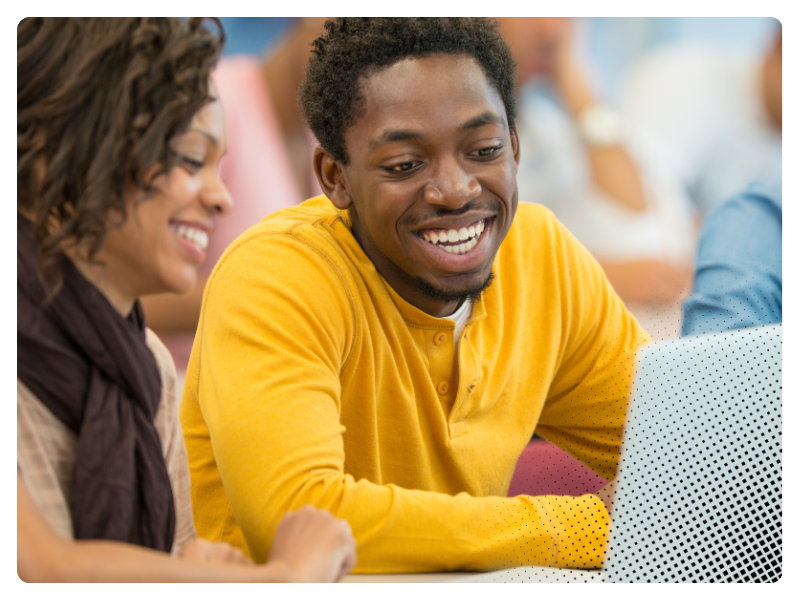 Two young people working together at a laptop