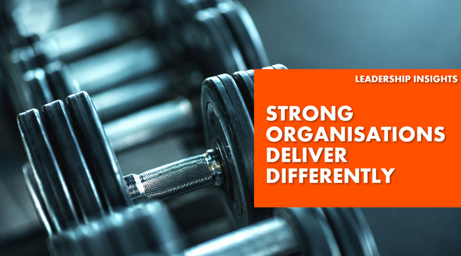 Strong Organisations Delivery Differently - text over weight lifting equipment