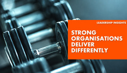 Strong Organisations Delivery Differently - text over weight lifting equipment