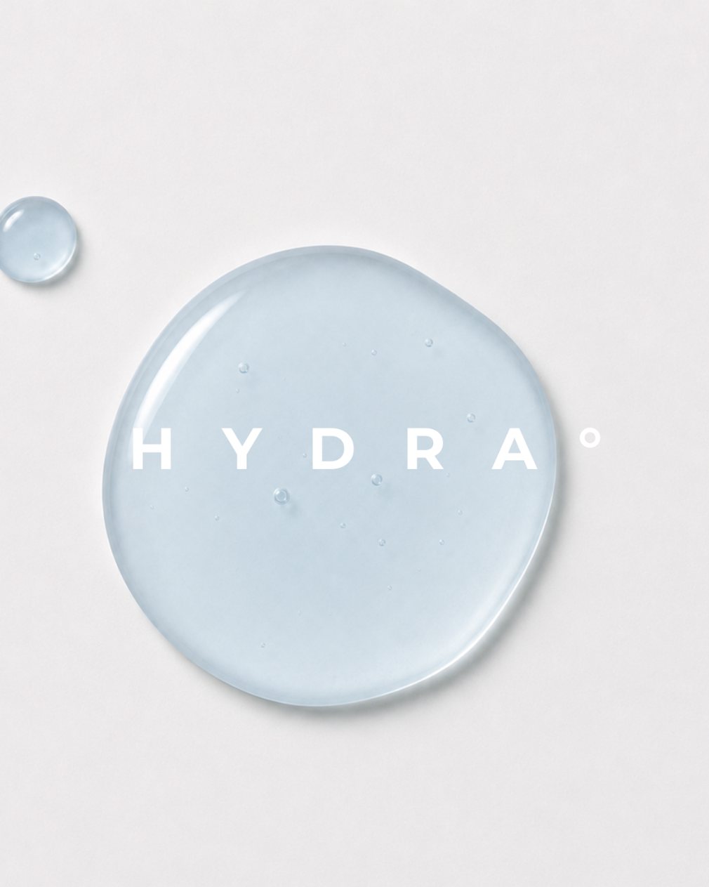HYDRA key visual: a pool of pale blue serum seen from above beside a smaller droplet, the name across it, AI concept work