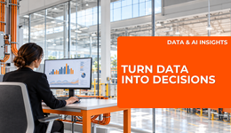 A woman reviewing business data in a bright modern factory office