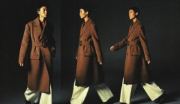 Three views of a model walking in a belted camel coat and cream trousers against a dark background, AI concept work