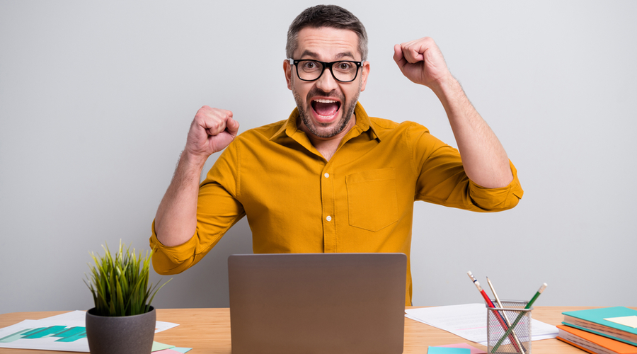 happy marketer at desk